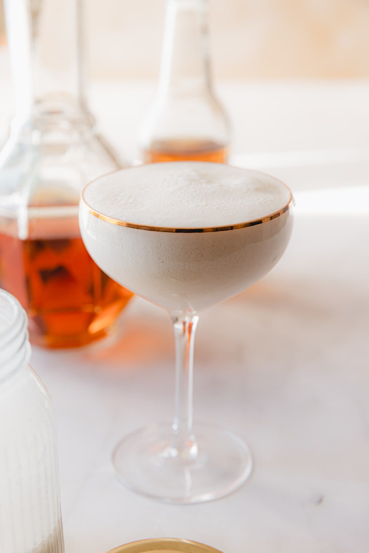 glass of bourbon cream mixed with cream soda in a coup glass