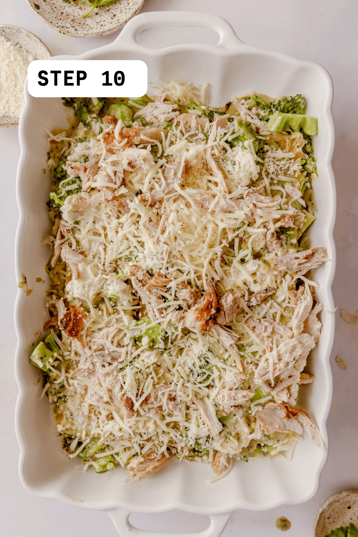 Unbaked Chicken Broccoli Lasagna topped with mozzarella. 