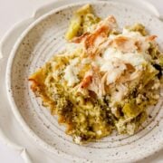 1 slice of chicken broccoli lasagna on a white plate.