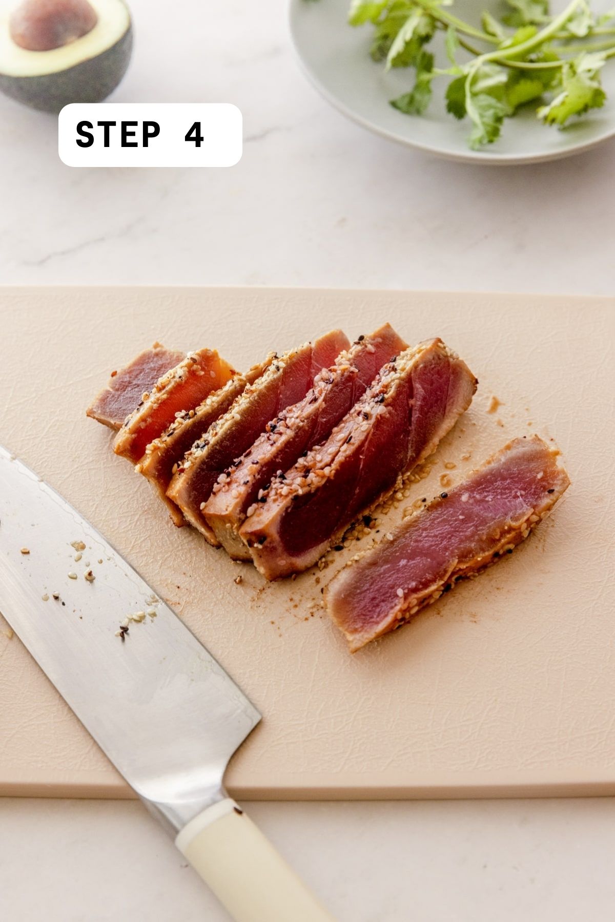 Sliced seared Ahi Tuna on a cutting board.