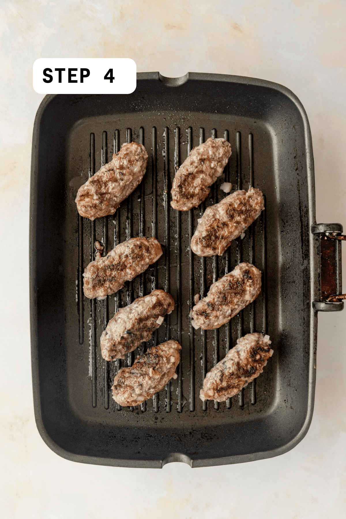 A grill pan with grilling beef koftas