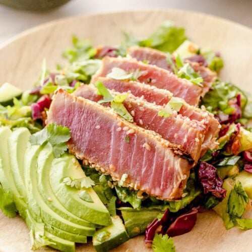 plate of sliced ahi tuna on a salad.