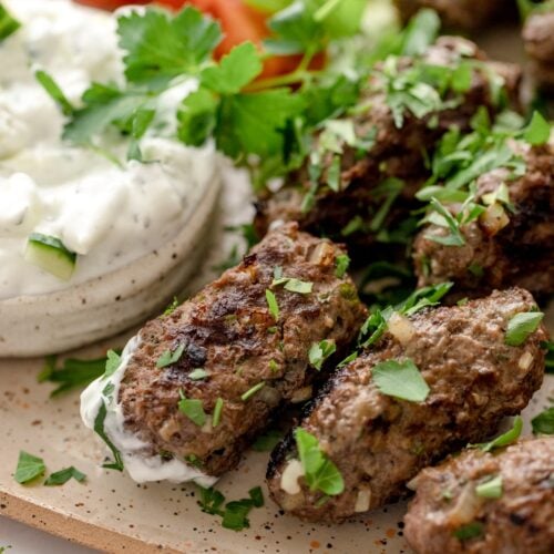Plate of beef kofta garnished with mint and parsley.