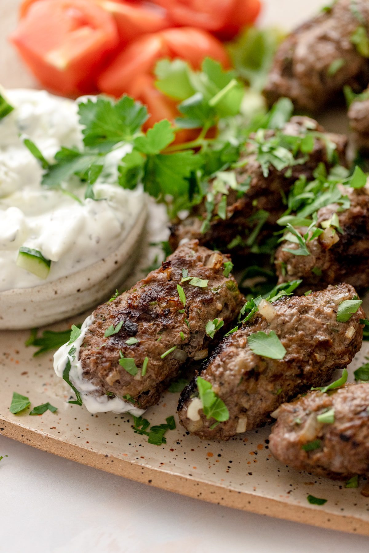 Plate of beef kofta garnished with mint and parsley. 