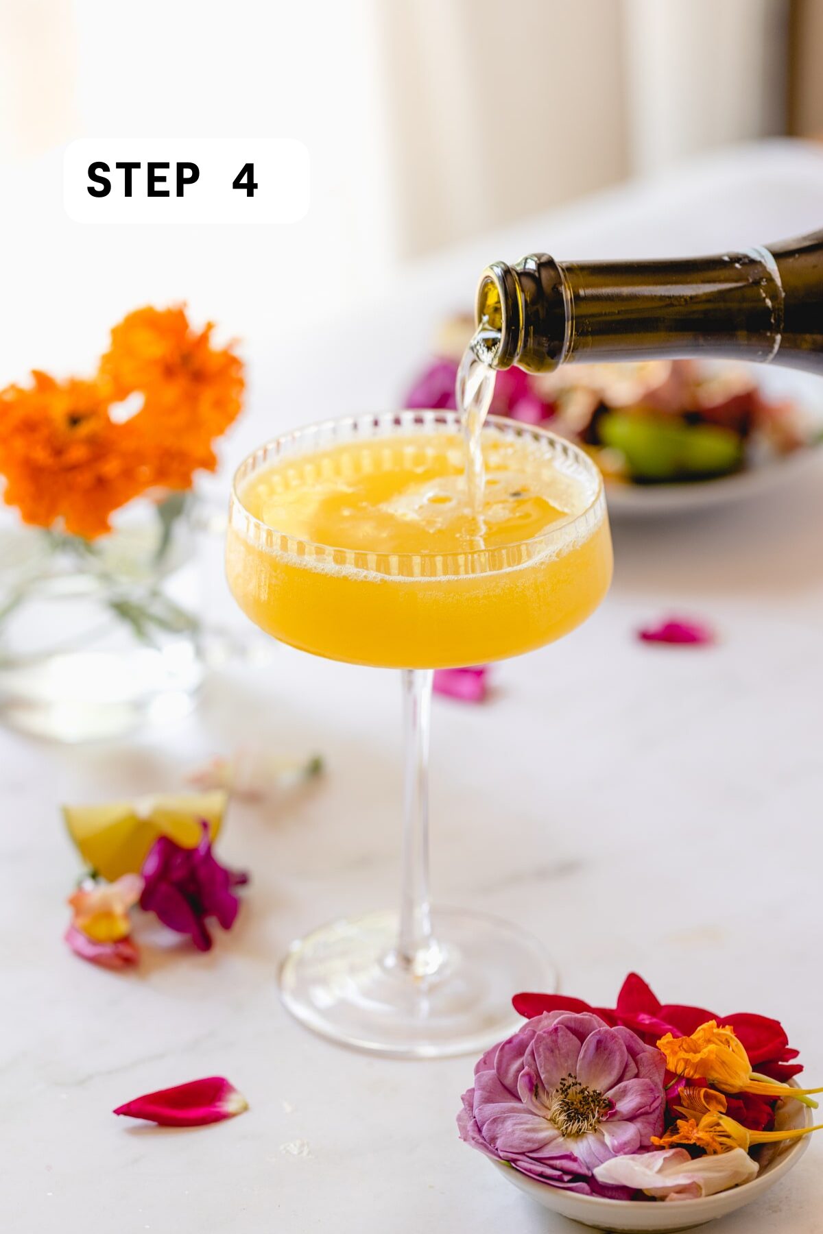 Pouring champagne into a passion fruit martini. 