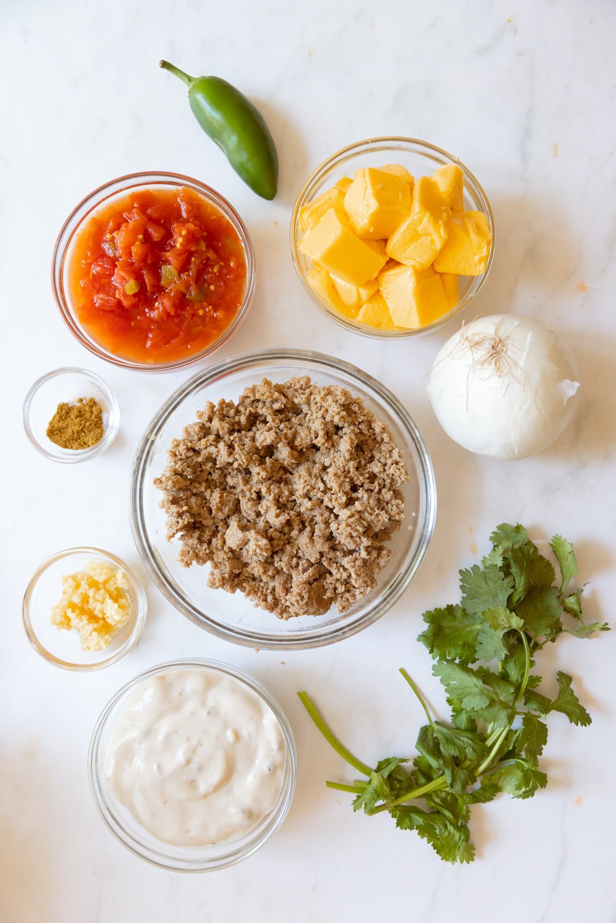 Smoked Queso ingredients in glass bowls.