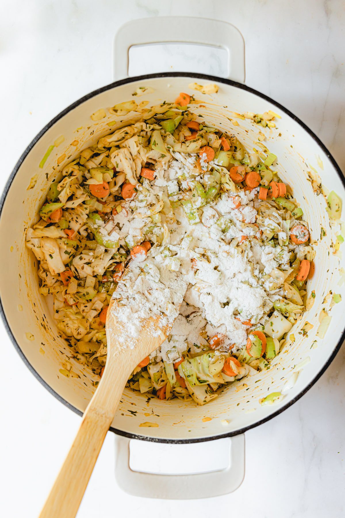 Butter and flour added to sautéed vegetables in a dutch oven. 