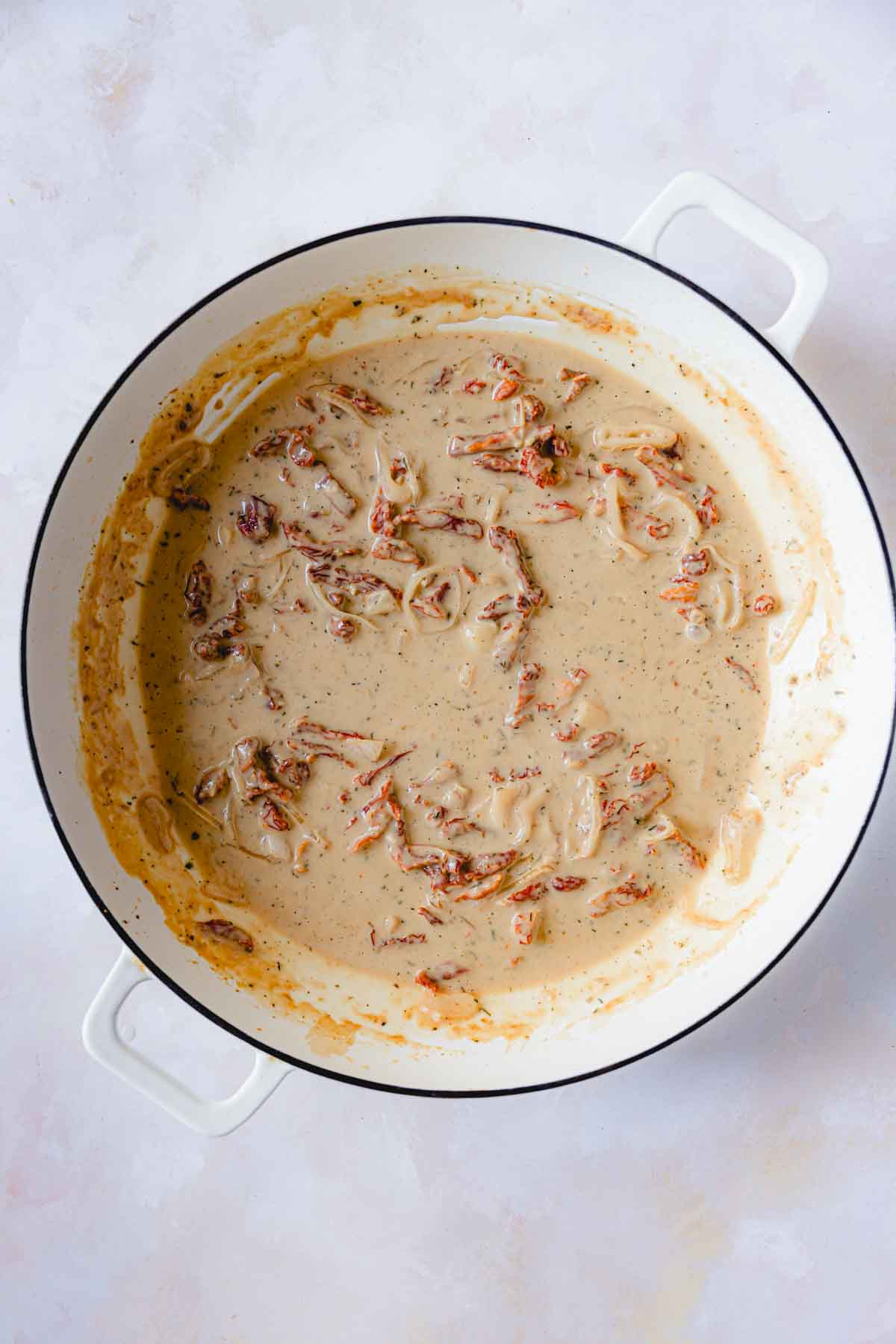 Cream and parmesan stirred into the sun-dried tomato sauce. 