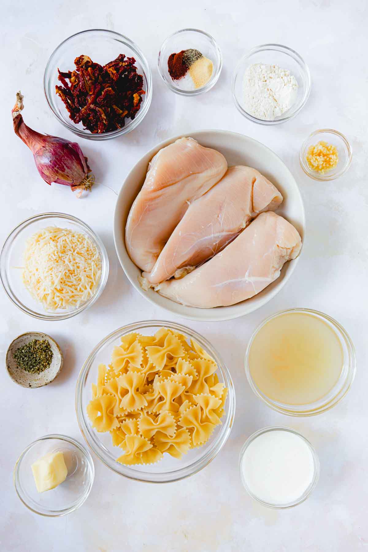 Ingredients for Marry Me Chicken Pasta in glass bowls. 