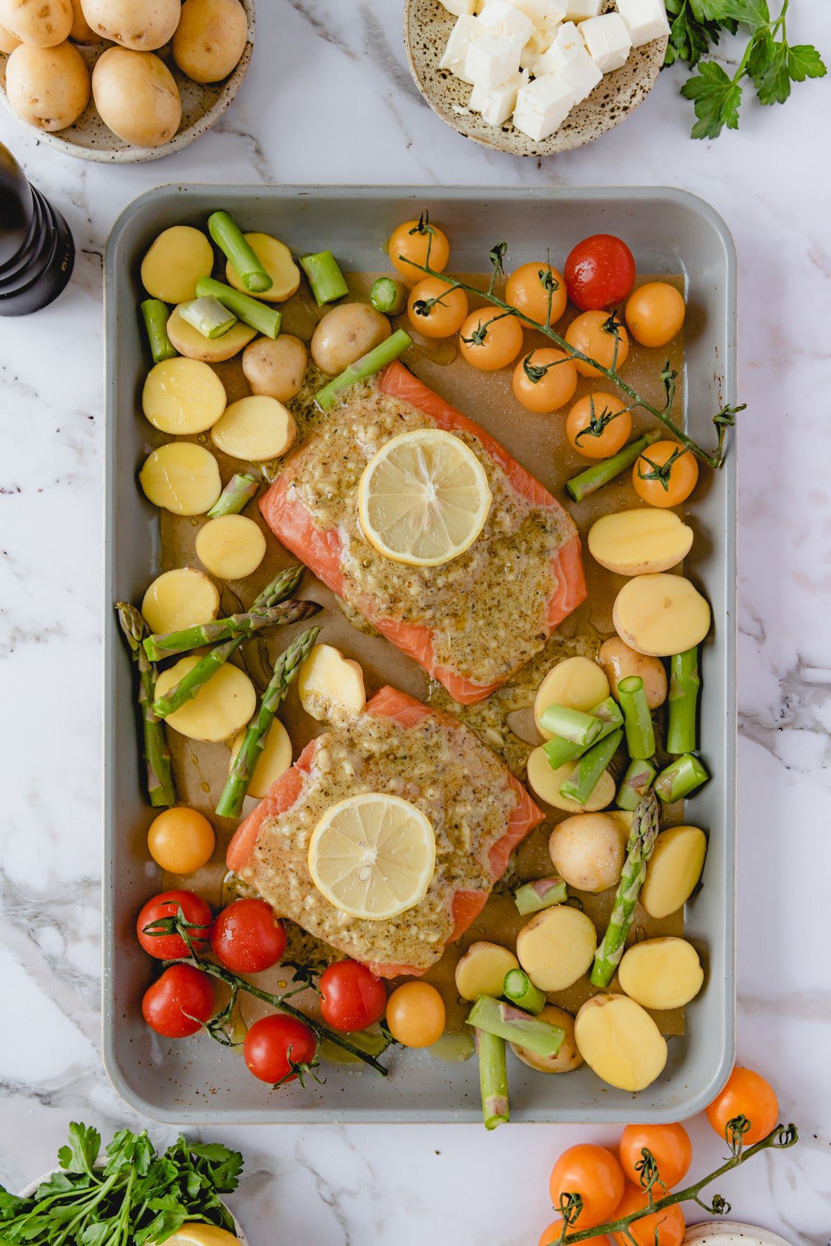 Cooked Mediterranean Salmon on a sheet tray.
