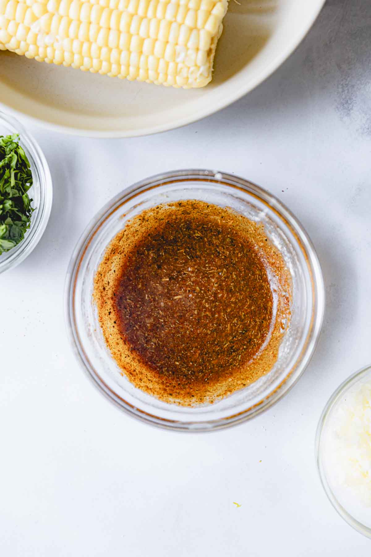 Melted butter and spices combined in a glass bowl. 