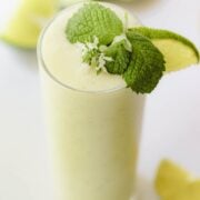 Garnish the mojito with mint and lime.