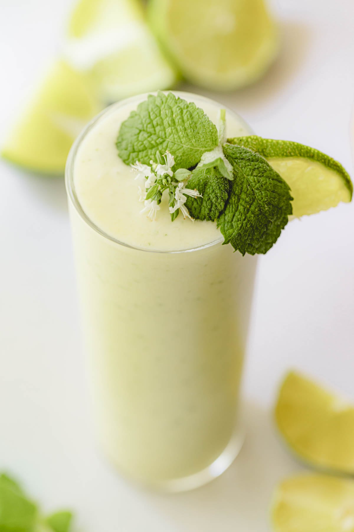 Garnish the mojito with mint and lime.