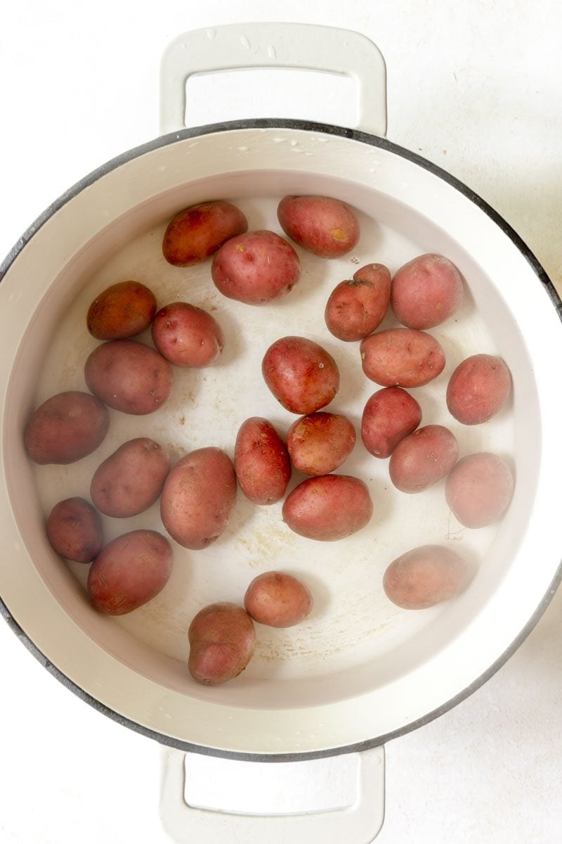 Red potatoes in a large pot of water.