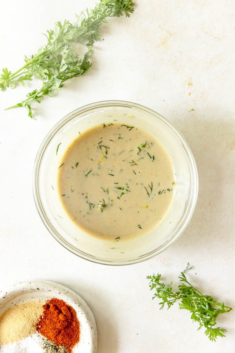 The dijon dipping sauce mixed together in a glass bowl. 