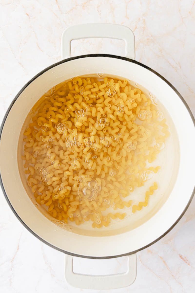 Boiling pasta in a white pot. 