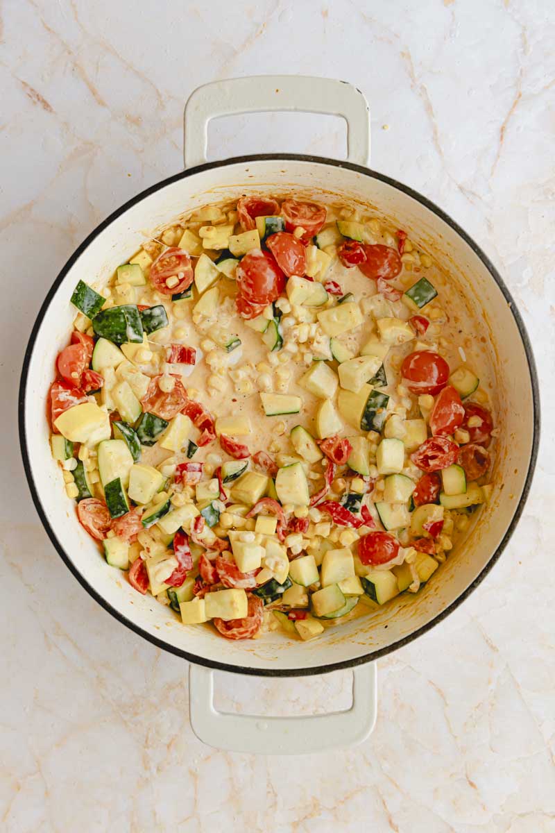 Cream and parmesan added to the vegetable skillet. 