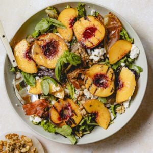 Final plated grilled peach salad with goat cheese.