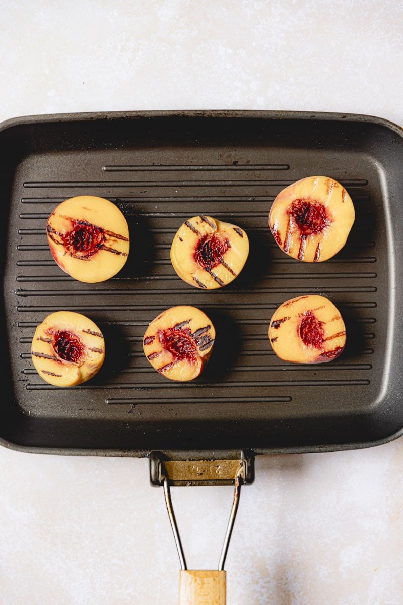 Grilled peaches on a grill pan. 