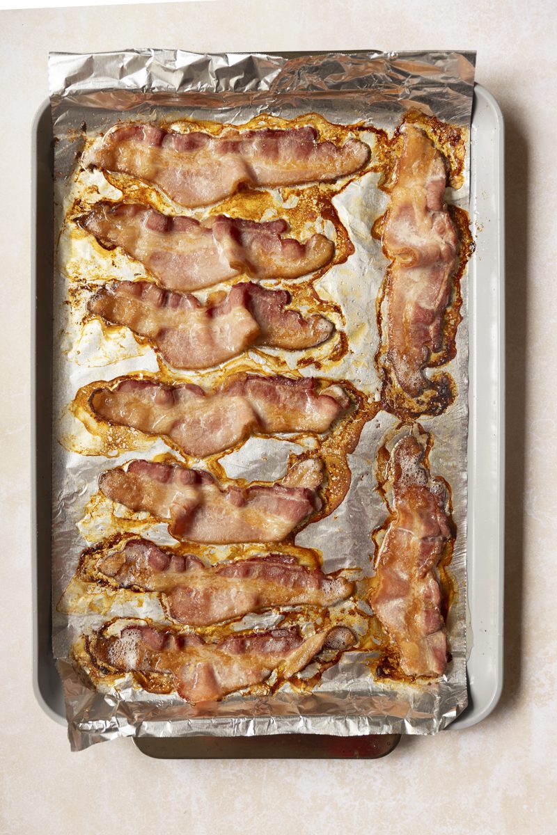 Cooked bacon on sheet tray. 