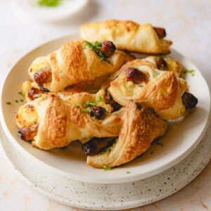 Plate of puff pastry wrapped breakfast sandwiches.