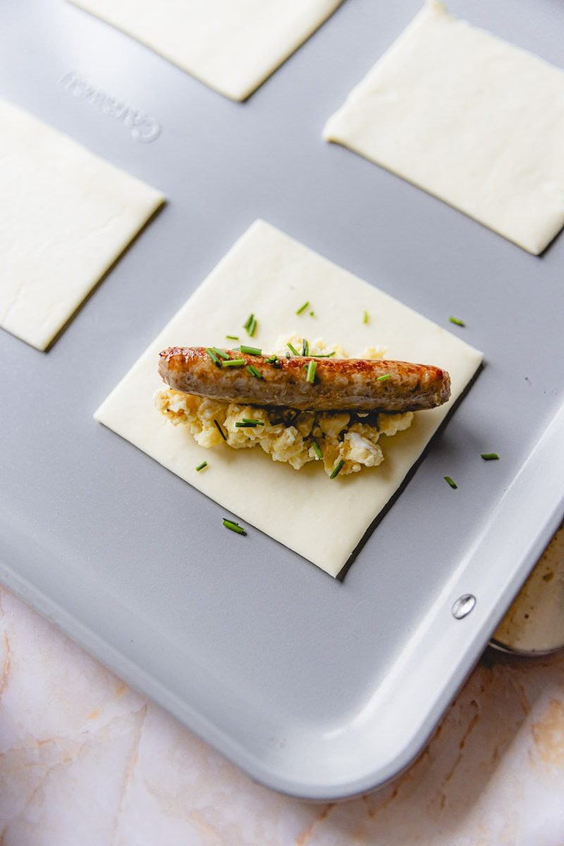 Sausage, egg, and chives layered onto a square of puff pastry.