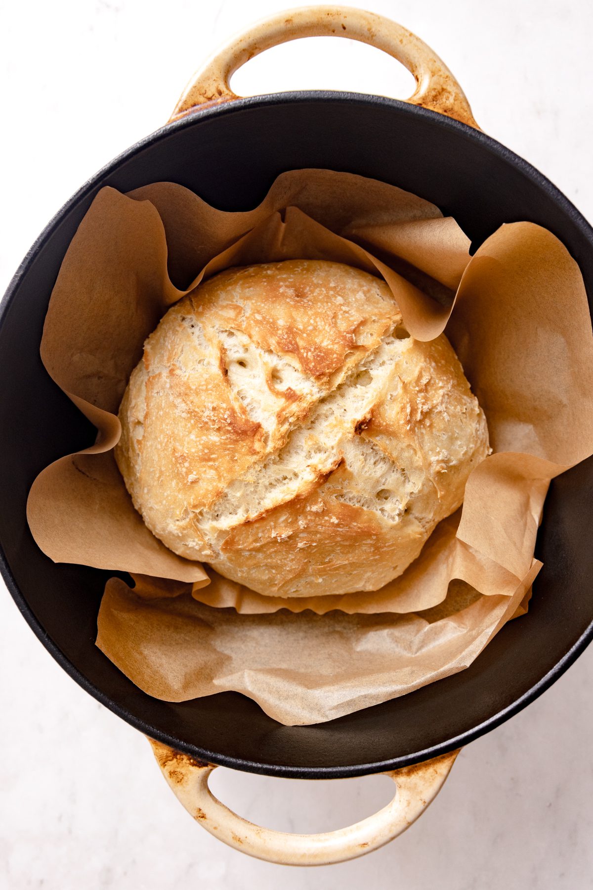Cooked bread loaf in dutch oven.