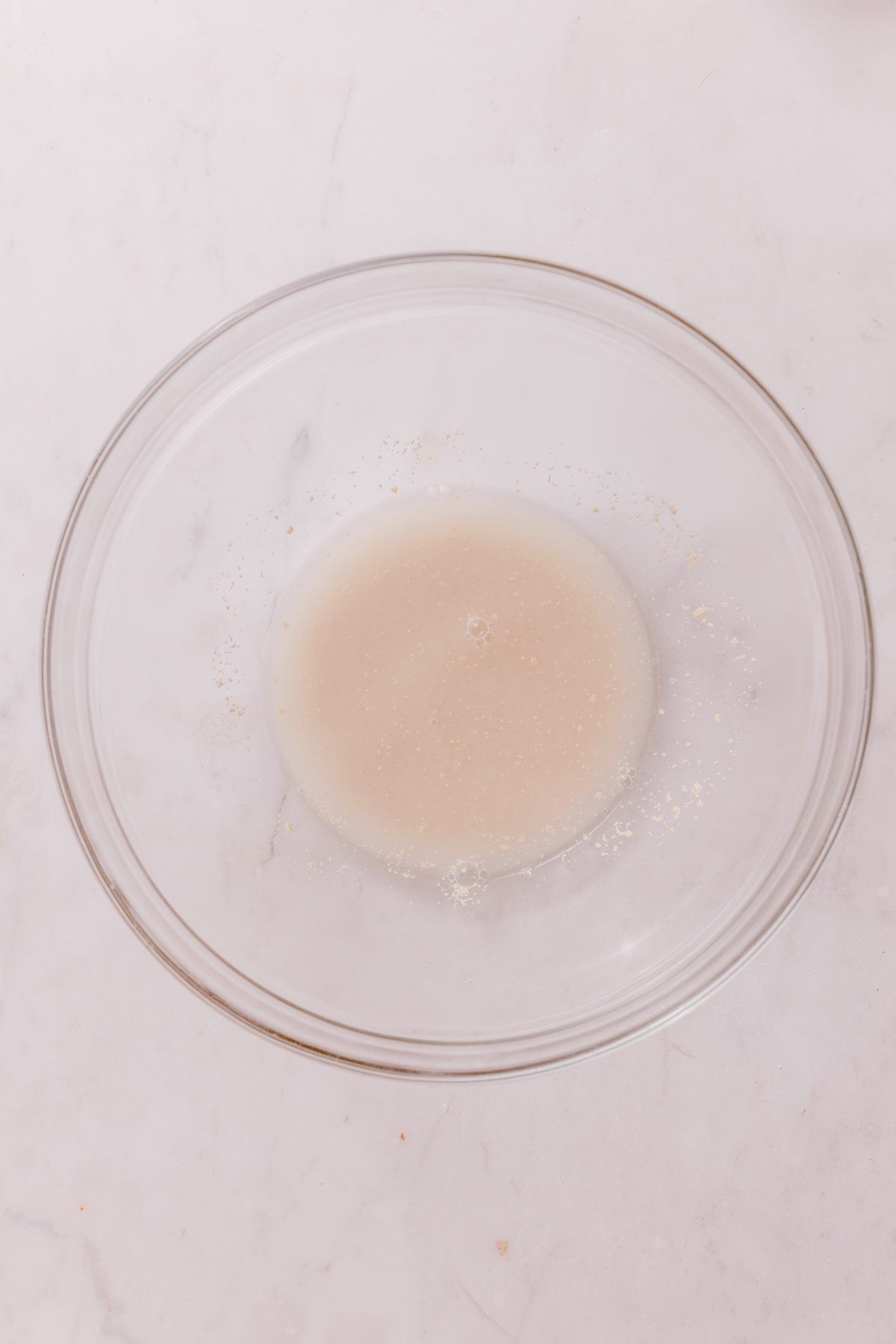 Water and yeast in a glass bowl. 