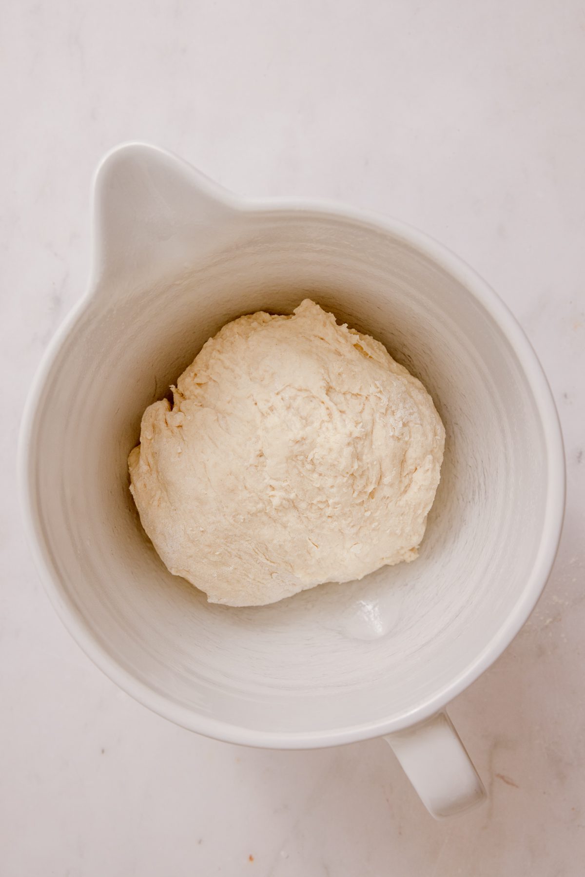 Dough beginning to rise in a bowl. 