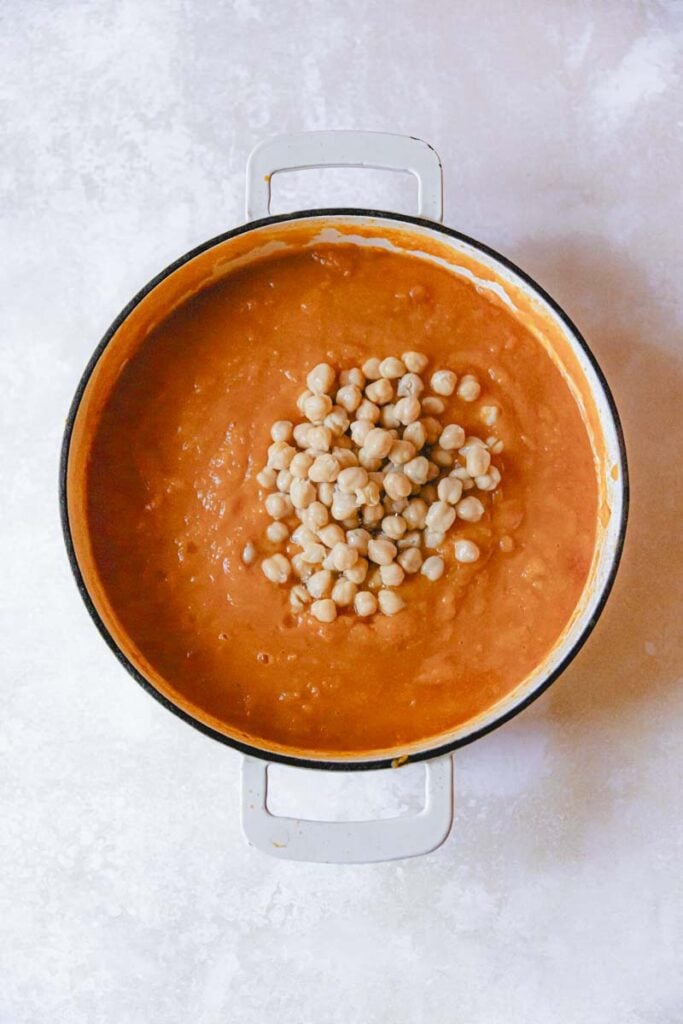 chickpeas added to the butternut squash curry skillet.