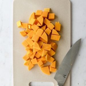 Diced butternut squash on a cutting board.