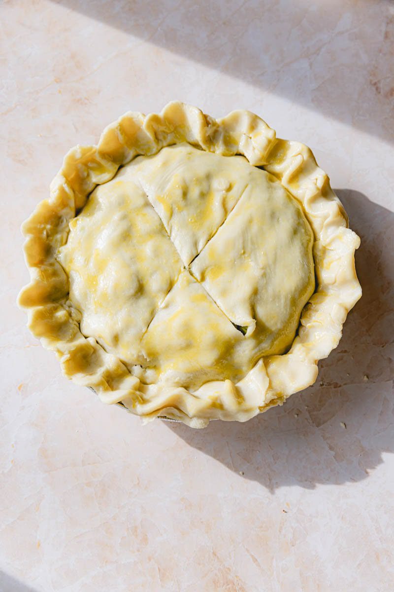 Top crust added to the ham pot pie and brushed with egg wash.