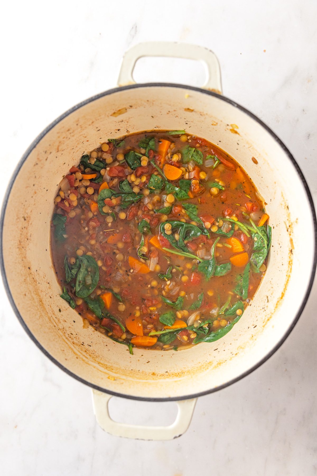 Wilted spinach cooked into turkey lentil soup.