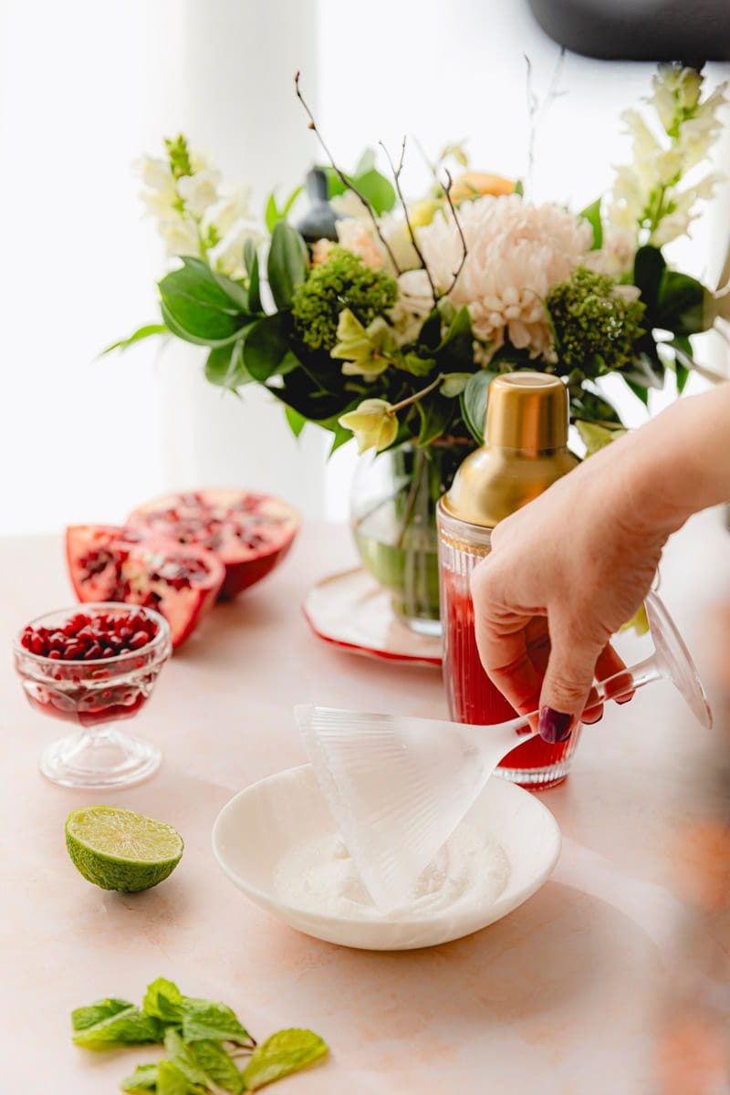 Rimming a chilled glass with sugar.