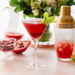 Final pomegranate martini garnished with mint.