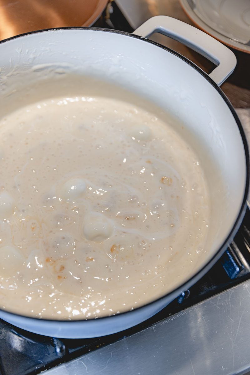 Melted marshmallows in a white saucepan.