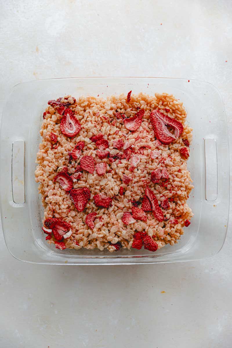 Pink Rice Krispie treats pressed into a glass 9x9 pan.