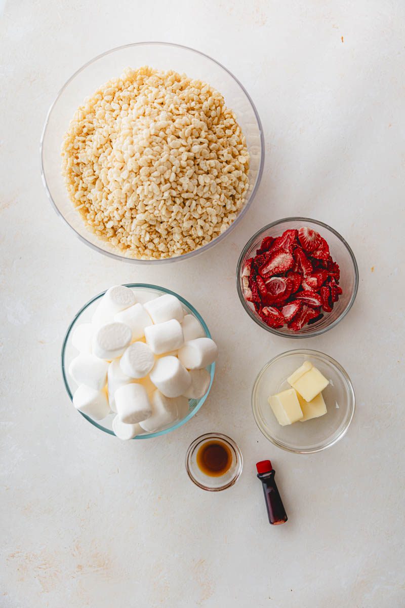 Pink Rice Krispie treat ingredients in glass bowls.